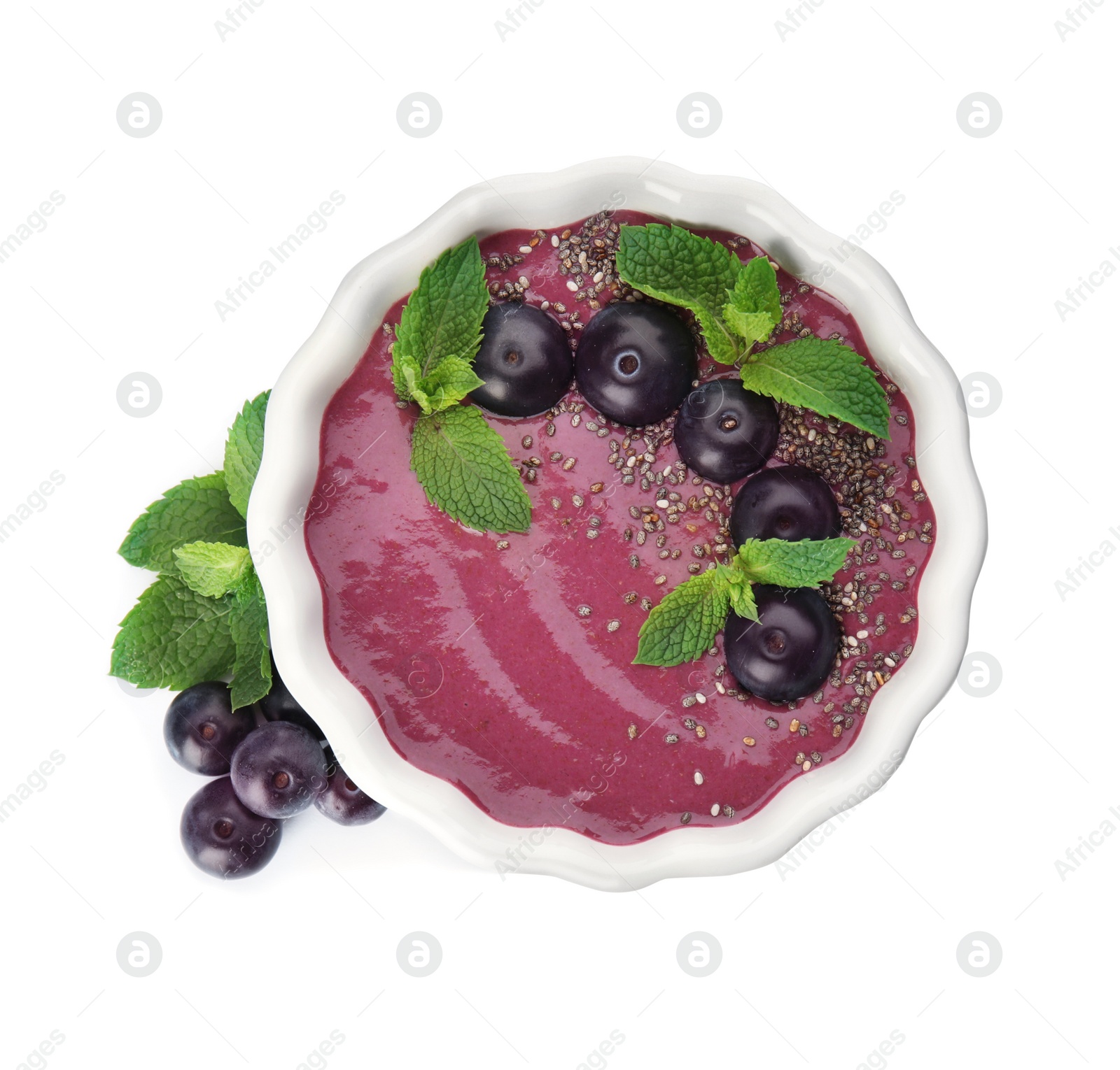 Photo of Bowl with tasty acai smoothie on white background, top view