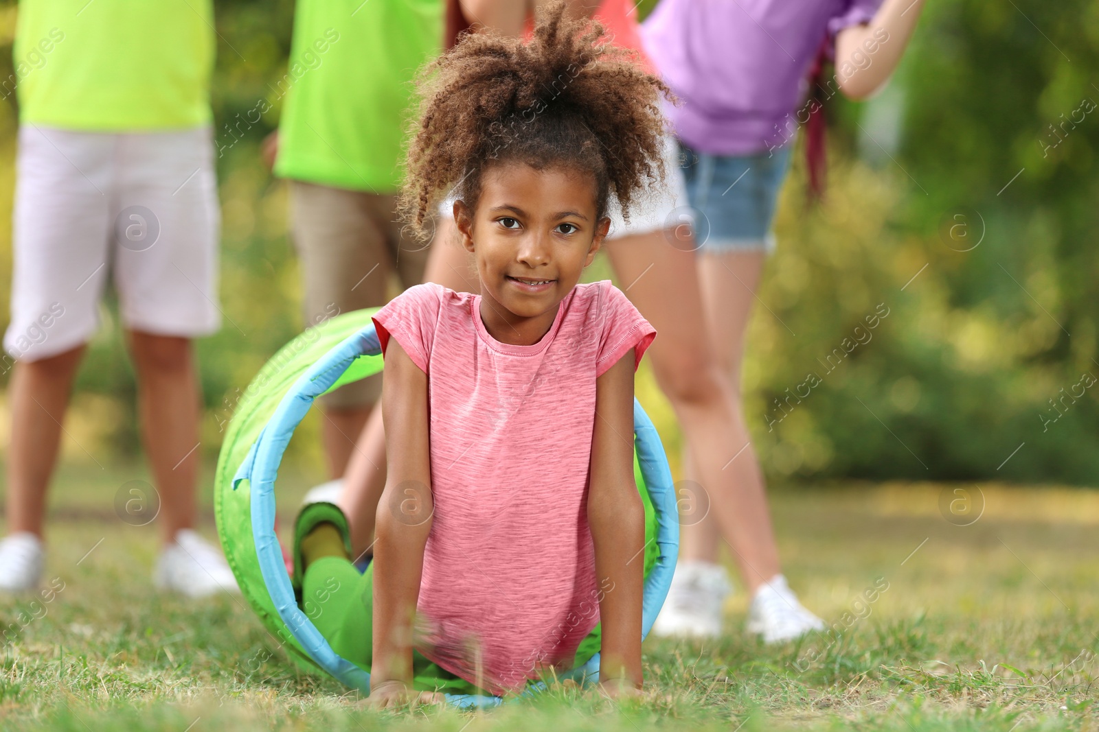 Photo of Cute little African-American child playing with friends in park