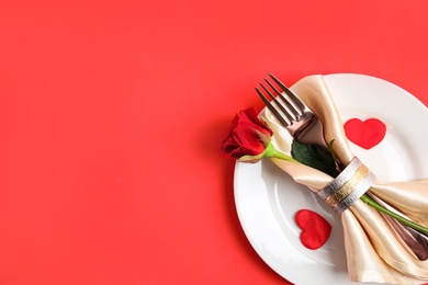 Romantic table setting on red background, top view with space for text. Valentine's day celebration