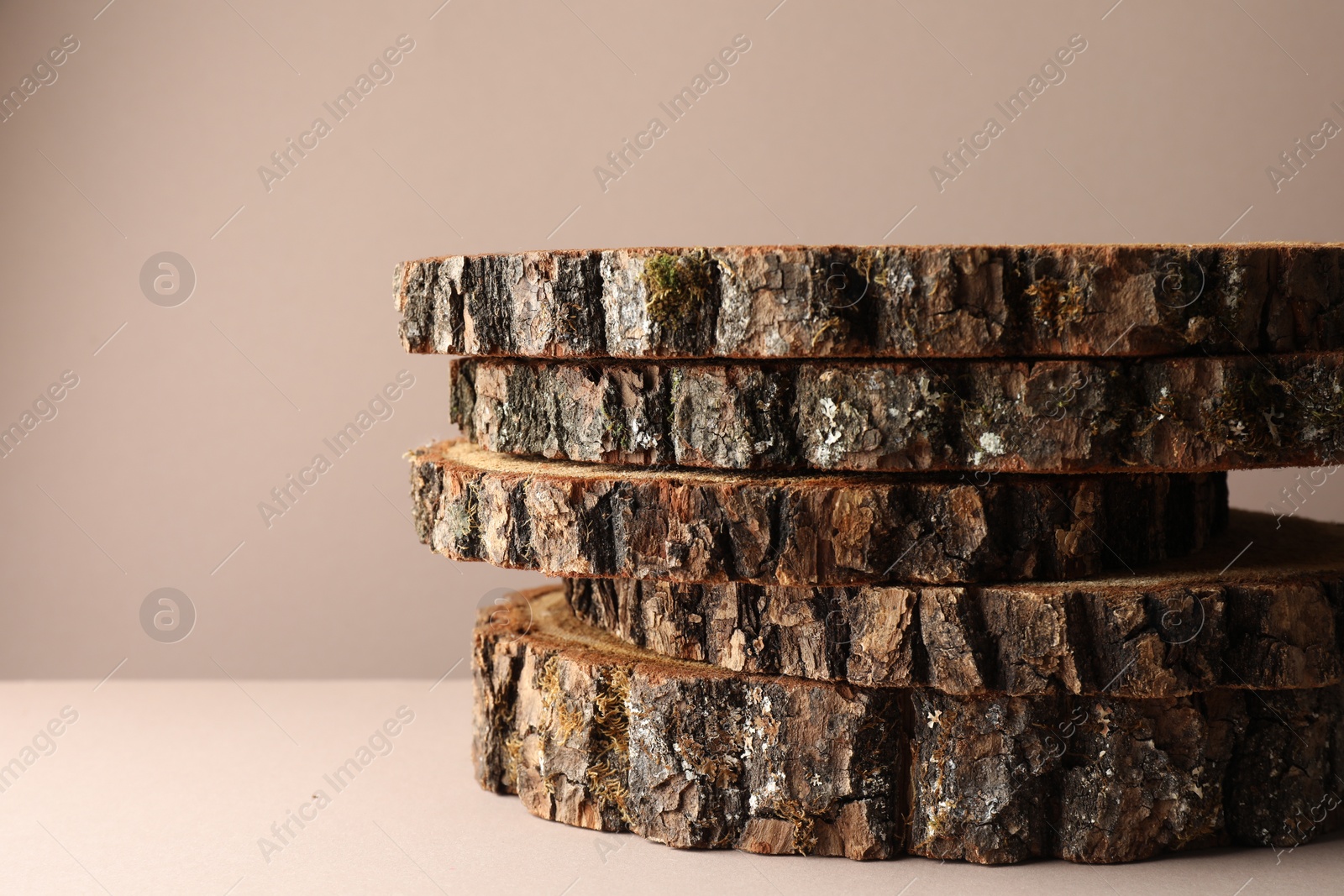 Photo of Presentation for product. Wooden stumps on beige background