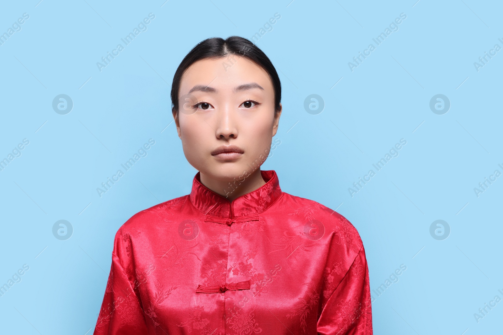 Photo of Portrait of young Asian woman on light blue background, space for text