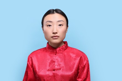 Photo of Portrait of young Asian woman on light blue background, space for text