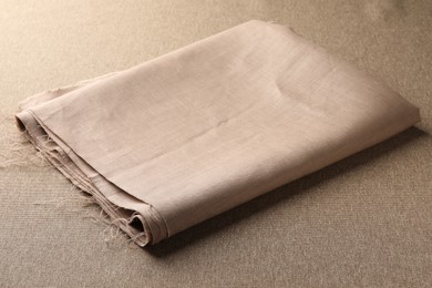 Photo of One folded light brown fabric on cloth
