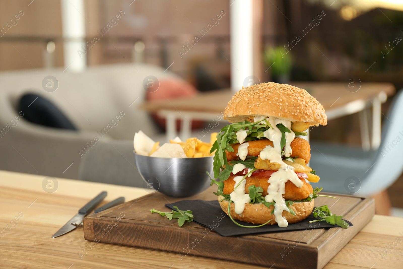 Photo of Huge yummy burger served on table in cafe. Space for text