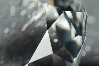 Beautiful dazzling diamond on blurred background, closeup view