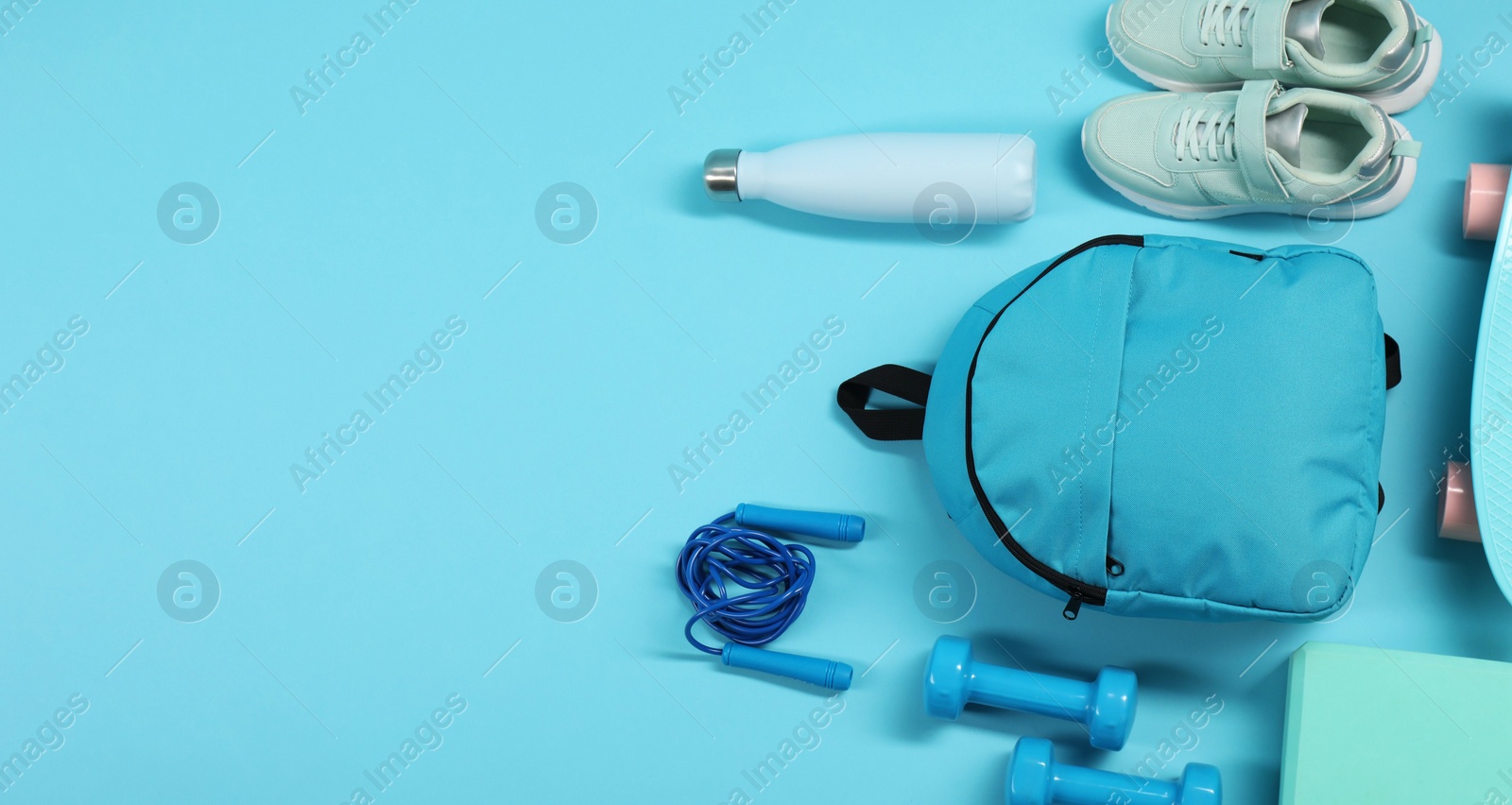 Photo of Different sports equipment on light blue background, flat lay. Space for text