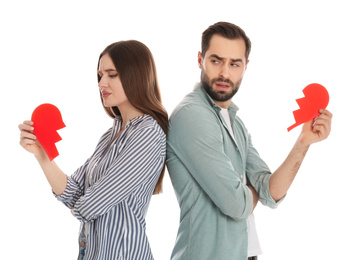 Photo of Couple with torn paper heart on white background. Relationship problems