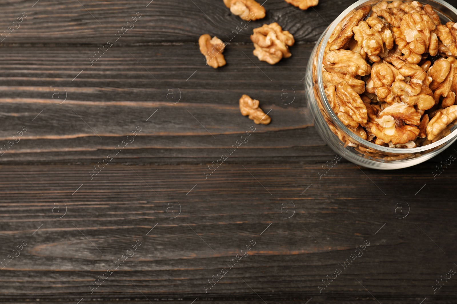 Photo of Flat lay composition with walnuts and space for text on wooden background