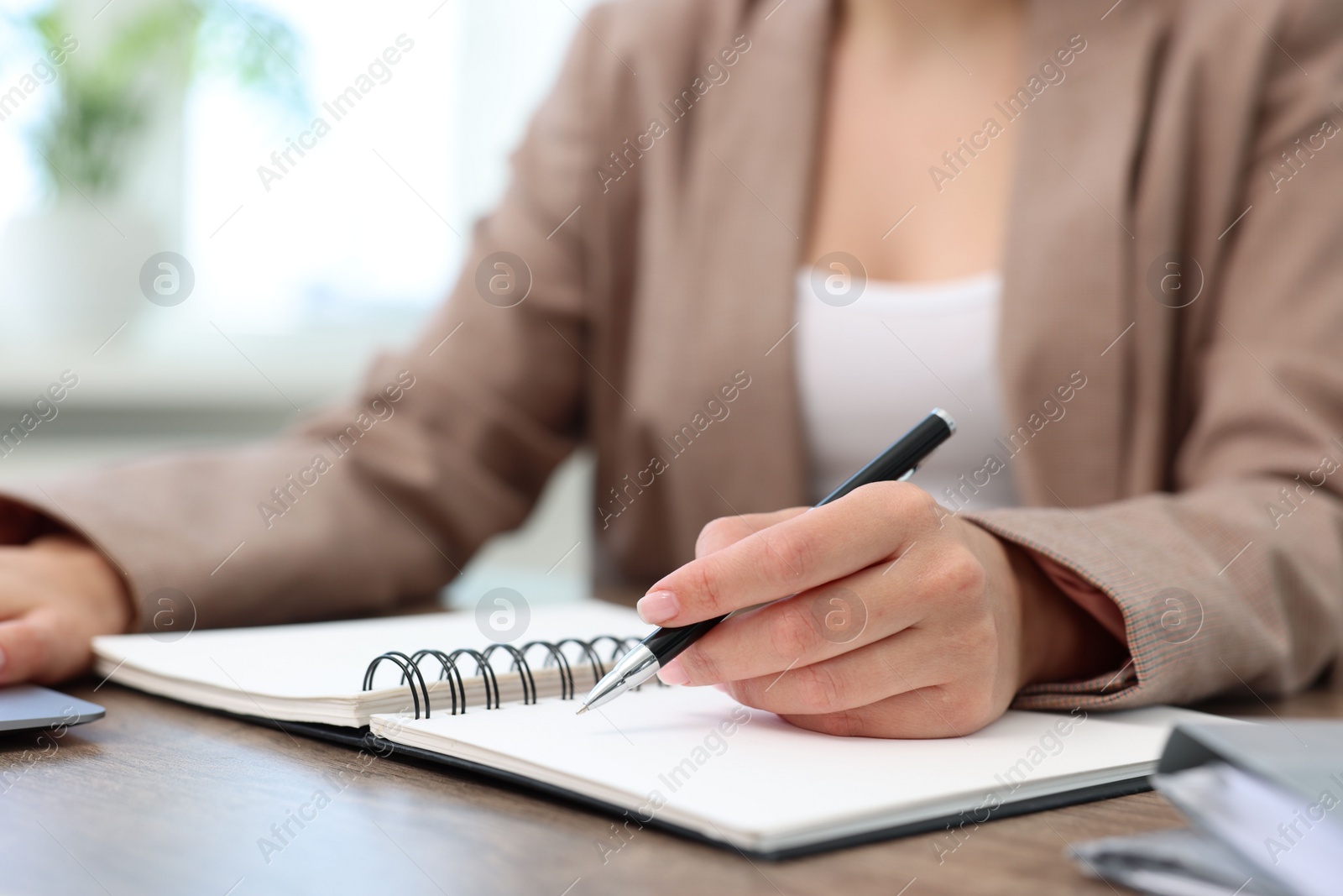 Photo of Secretary working at table in office, closeup