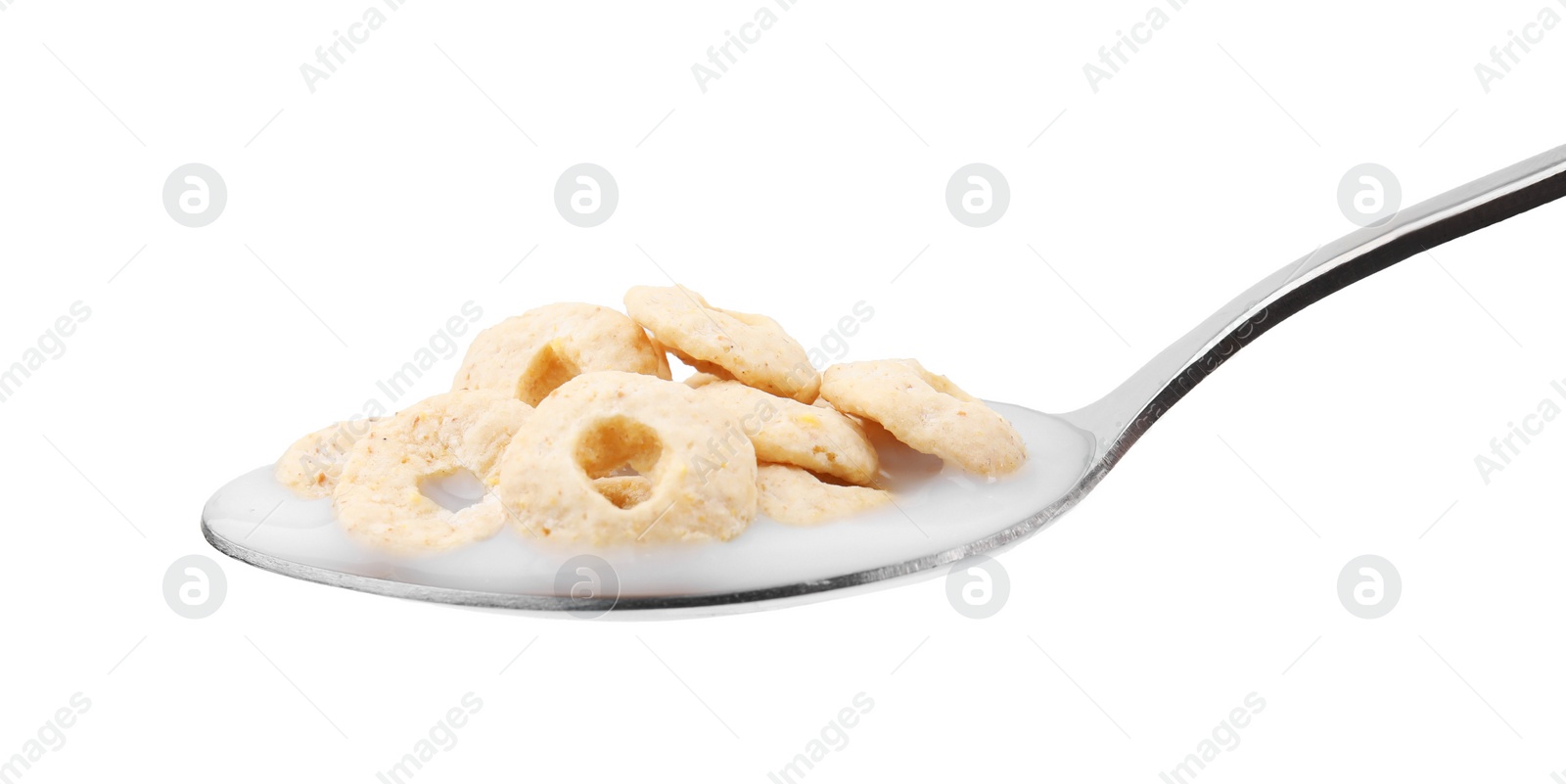 Photo of Cereal rings and milk in spoon isolated on white