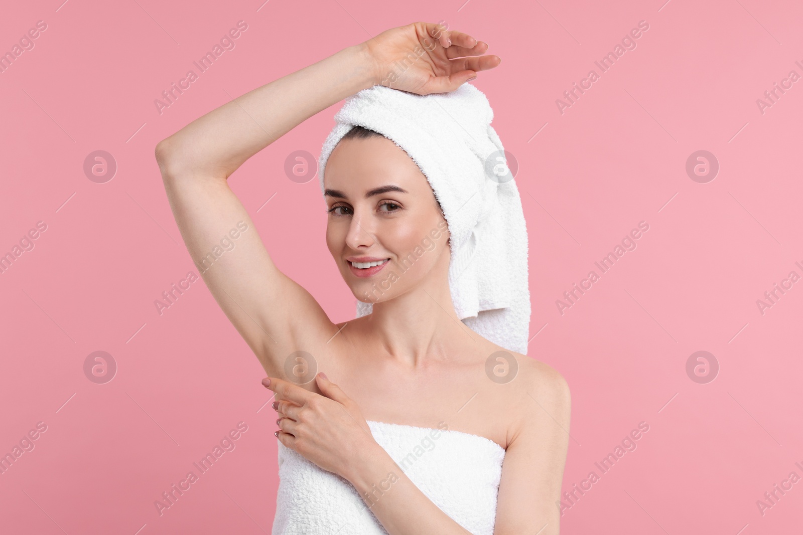 Photo of Beautiful woman showing armpit with smooth clean skin on pink background