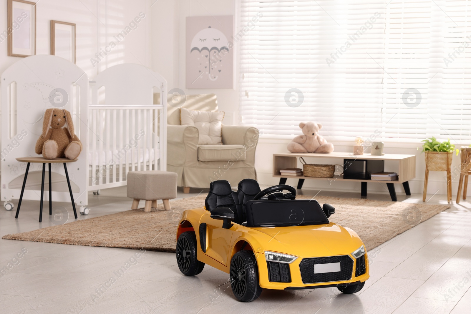 Photo of Yellow car in room at home. Child's toy