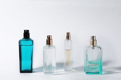 Photo of Bottles of perfume on light background