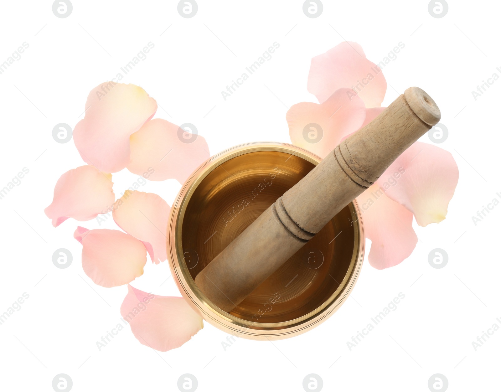 Photo of Golden singing bowl with mallet and petals on white background, top view. Sound healing