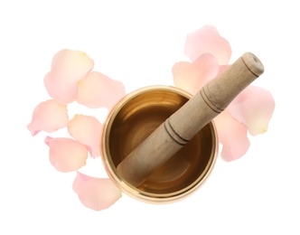 Photo of Golden singing bowl with mallet and petals on white background, top view. Sound healing