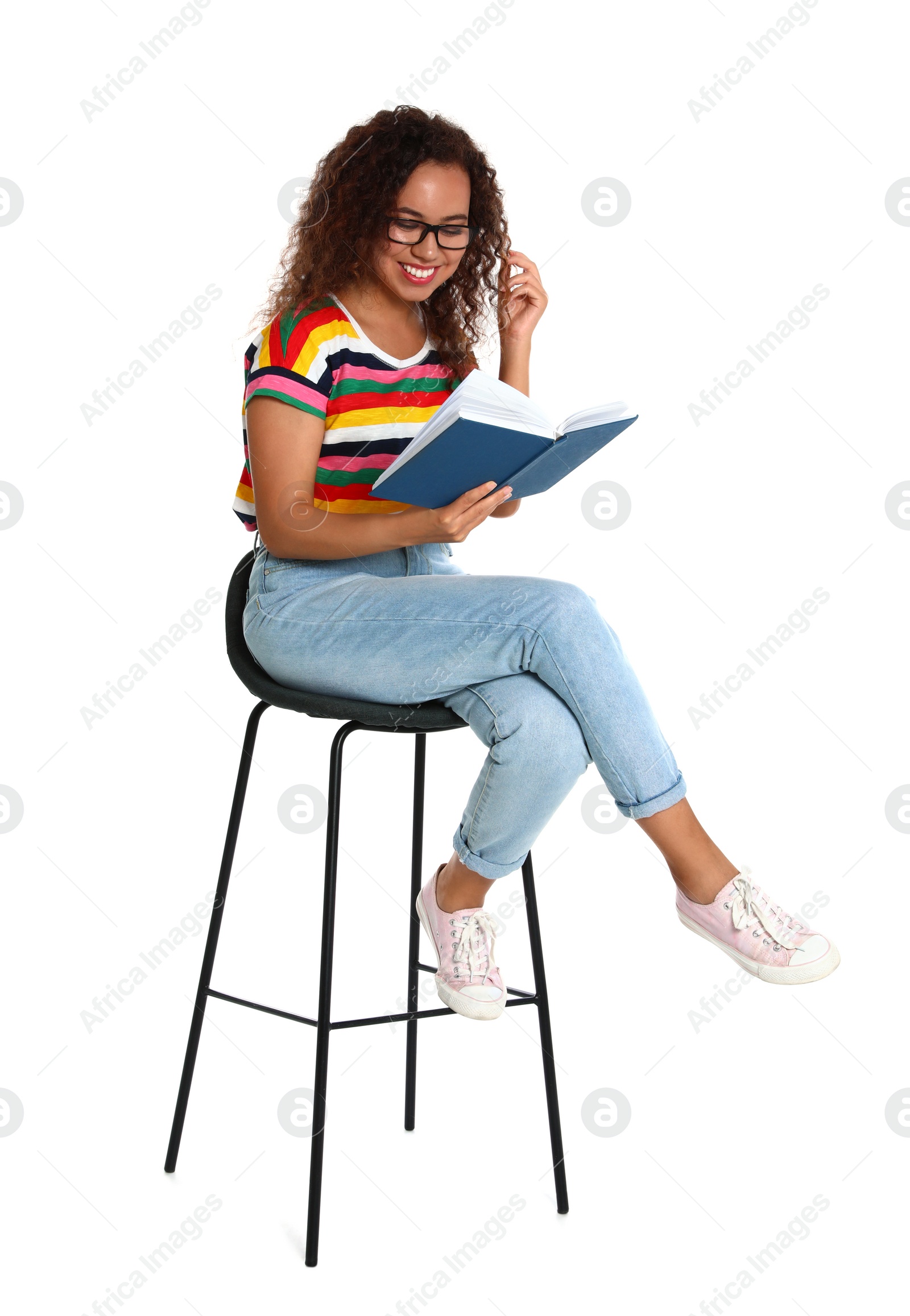 Photo of Beautiful African-American woman reading book on white background