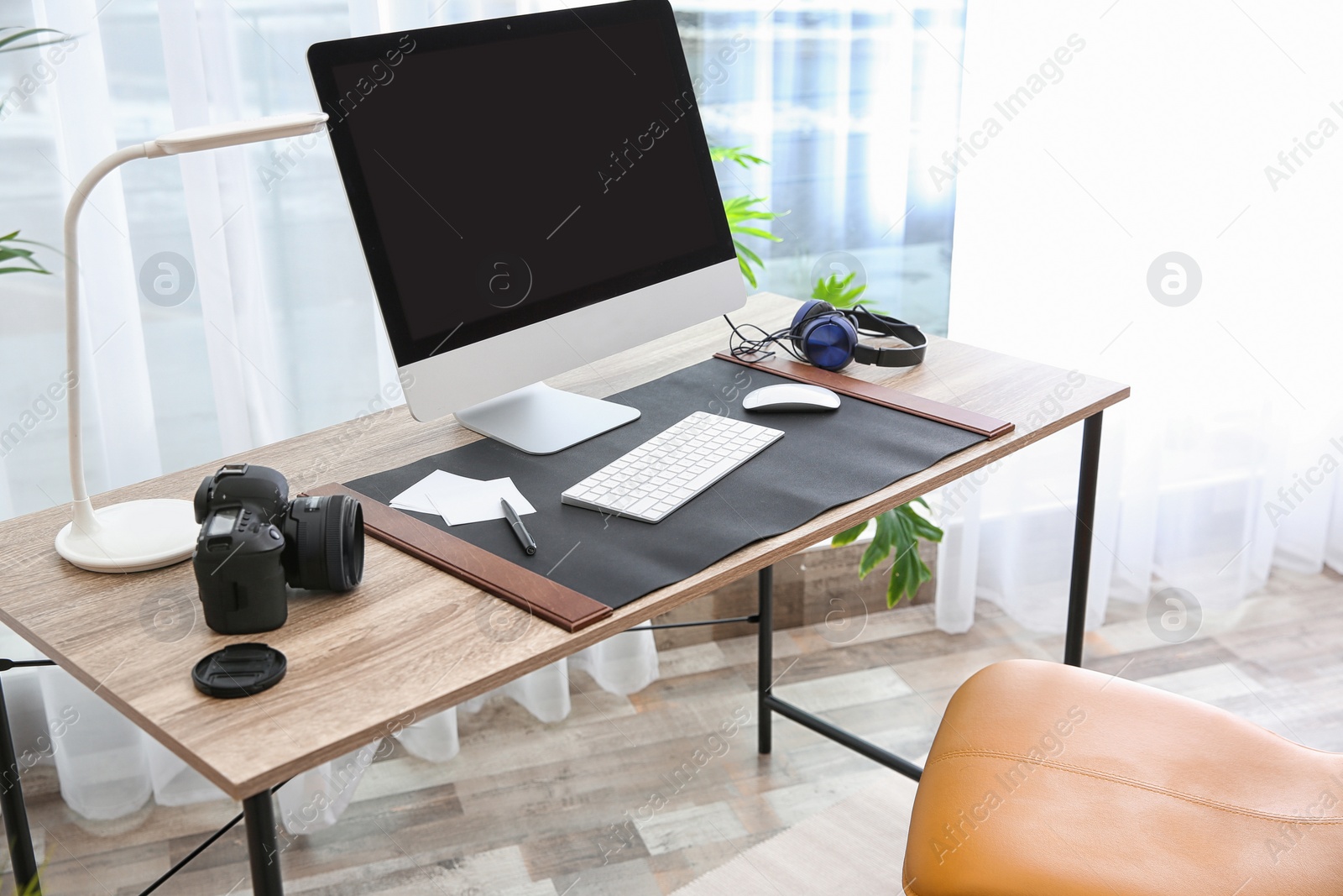 Photo of Light modern interior of working place with computer