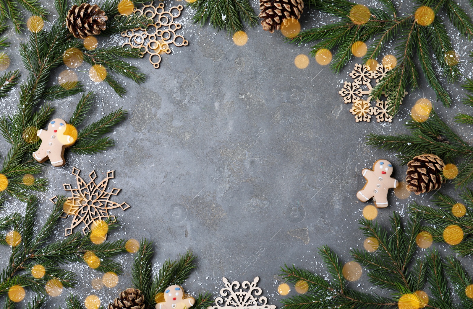 Photo of Flat lay composition with fir branches and Christmas decor on grey background, space for text. Greeting card design