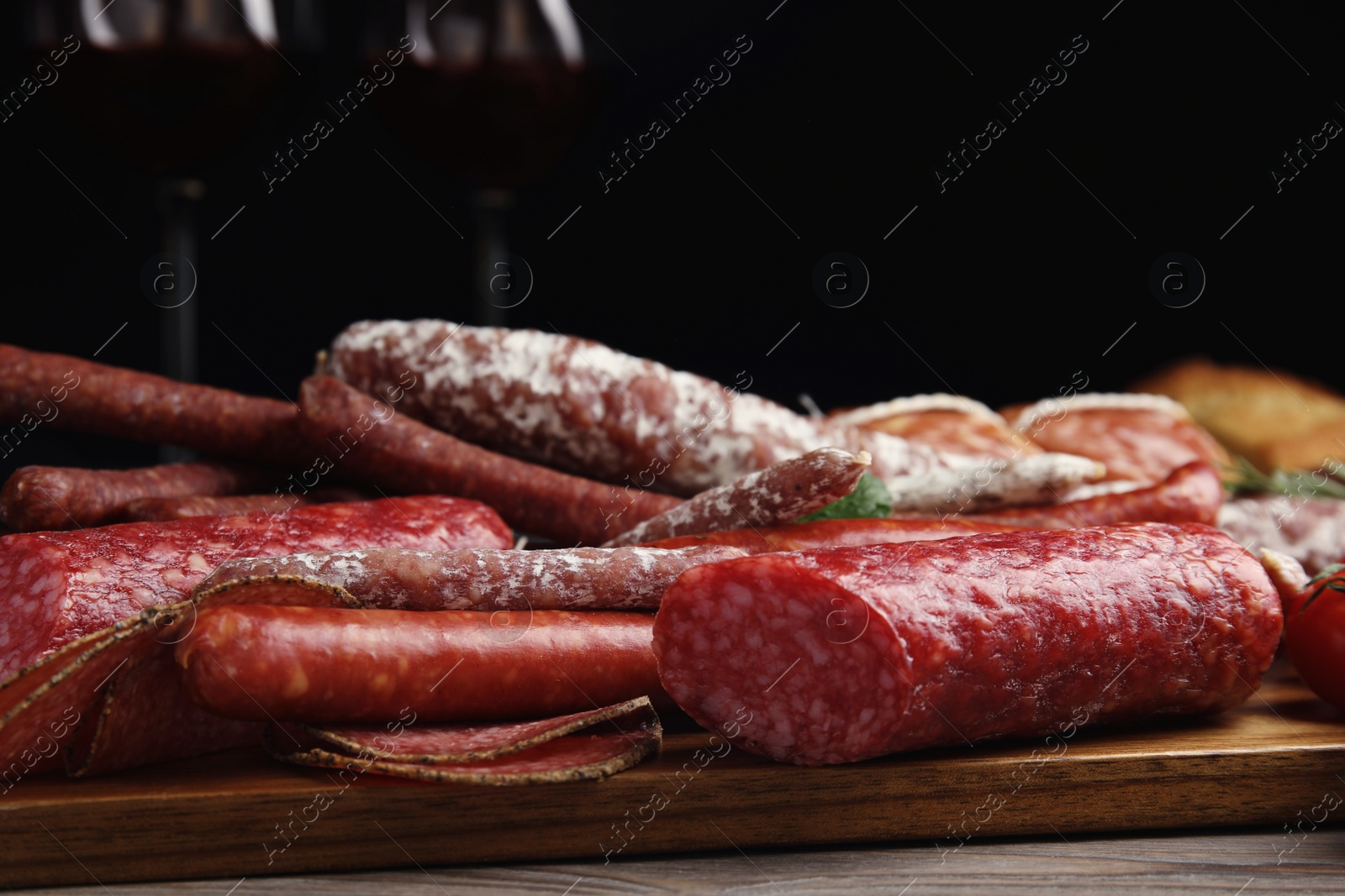 Photo of Different tasty sausages on wooden table, closeup