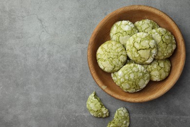 Bowl with tasty matcha cookies on grey textured table, flat lay. Space for text