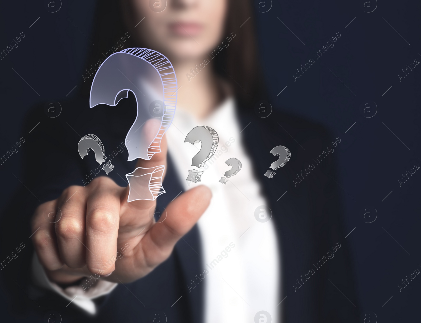 Image of Businesswoman on dark background touching drawing of question mark