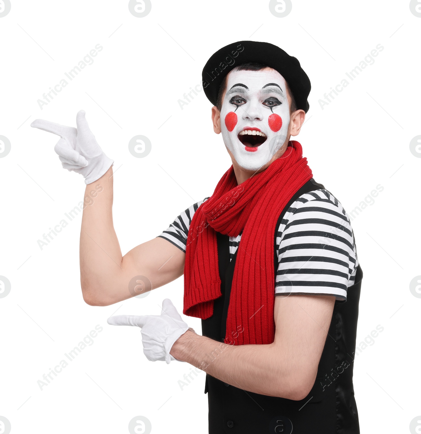 Photo of Funny mime artist pointing at something on white background