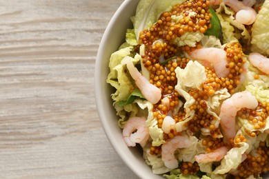 Photo of Delicious salad with Chinese cabbage, shrimps and mustard seed dressing on white wooden table, top view. Space for text