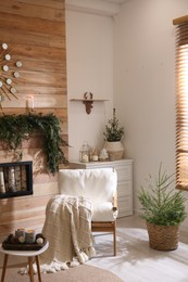 Photo of Beautiful room decorated for Christmas with potted firs. Interior design