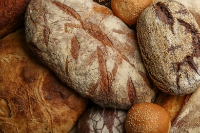 Photo of Different kindsdelicious bread as background, top view