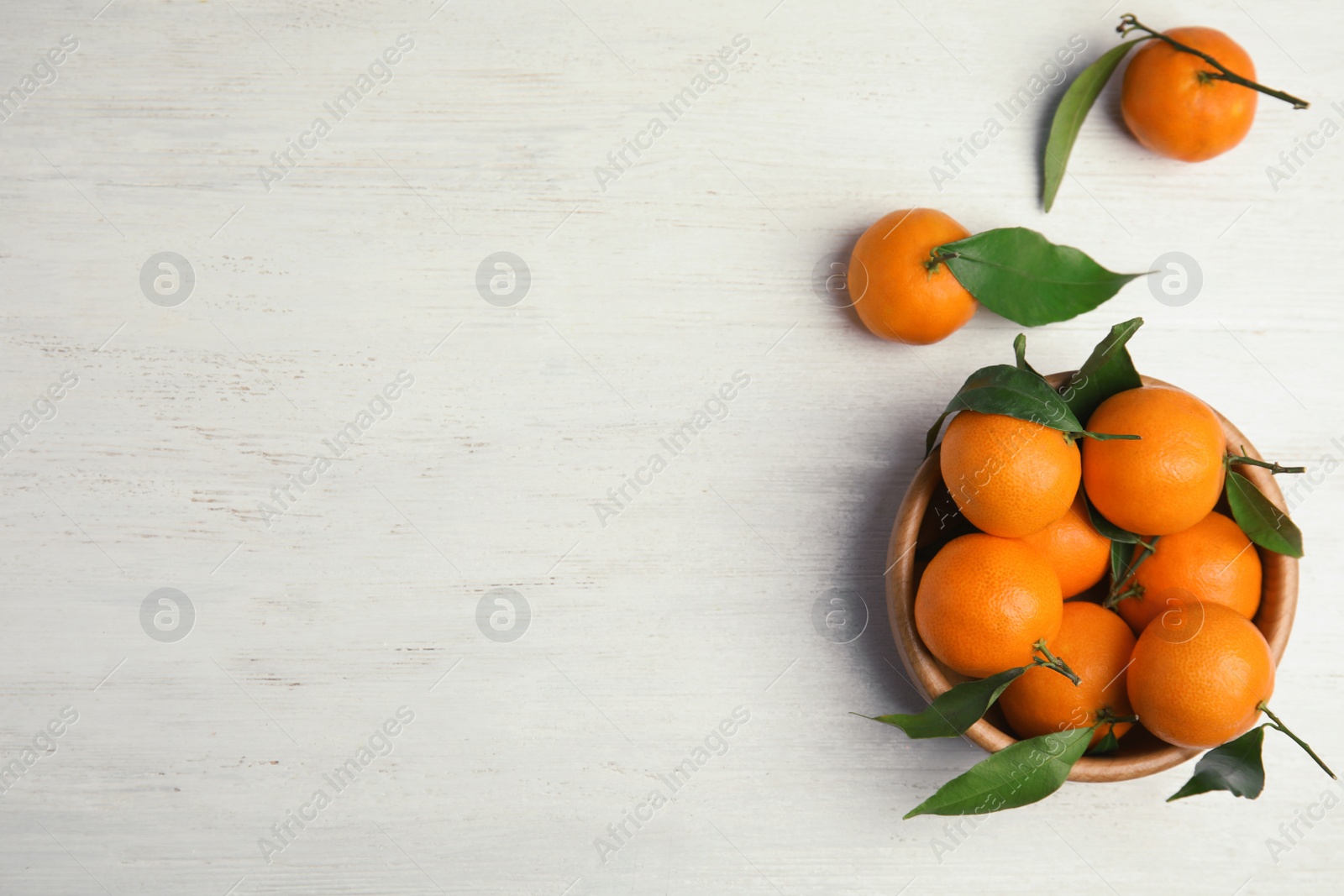 Photo of Flat lay composition with fresh ripe tangerines and space for text on wooden background