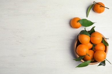 Flat lay composition with fresh ripe tangerines and space for text on wooden background