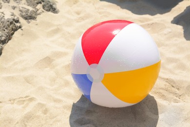 Colorful inflatable ball at beach on sunny day
