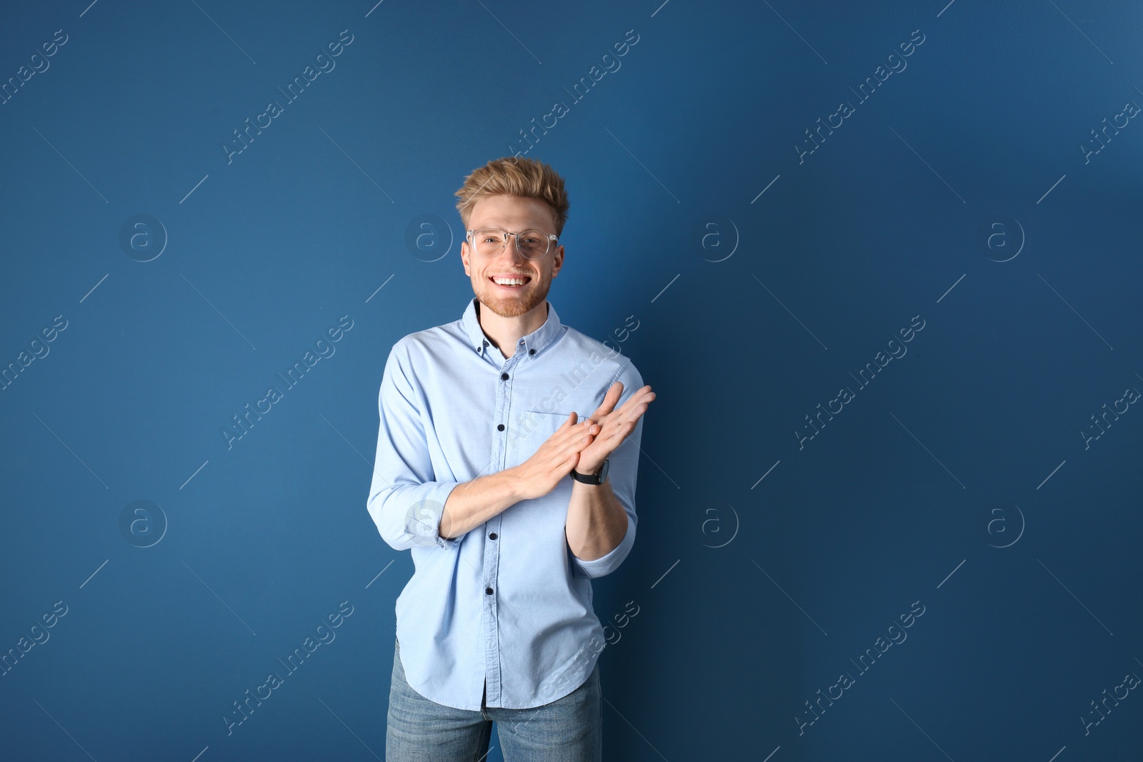 Photo of Portrait of handsome young man on blue background