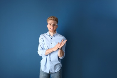 Portrait of handsome young man on blue background