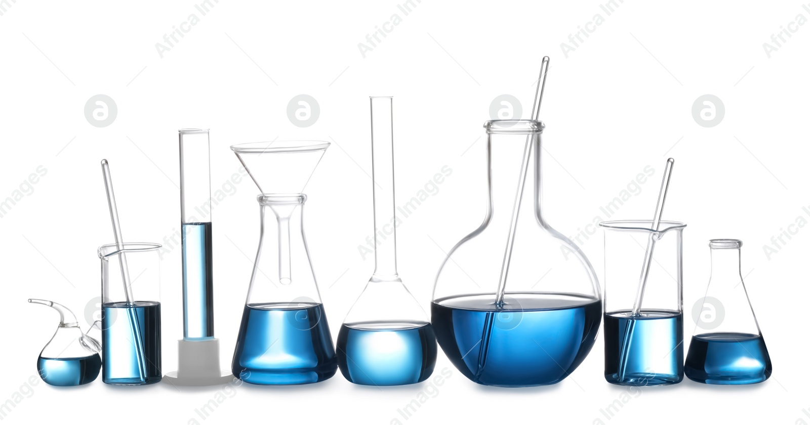 Photo of Set of laboratory glassware with blue liquid isolated on white