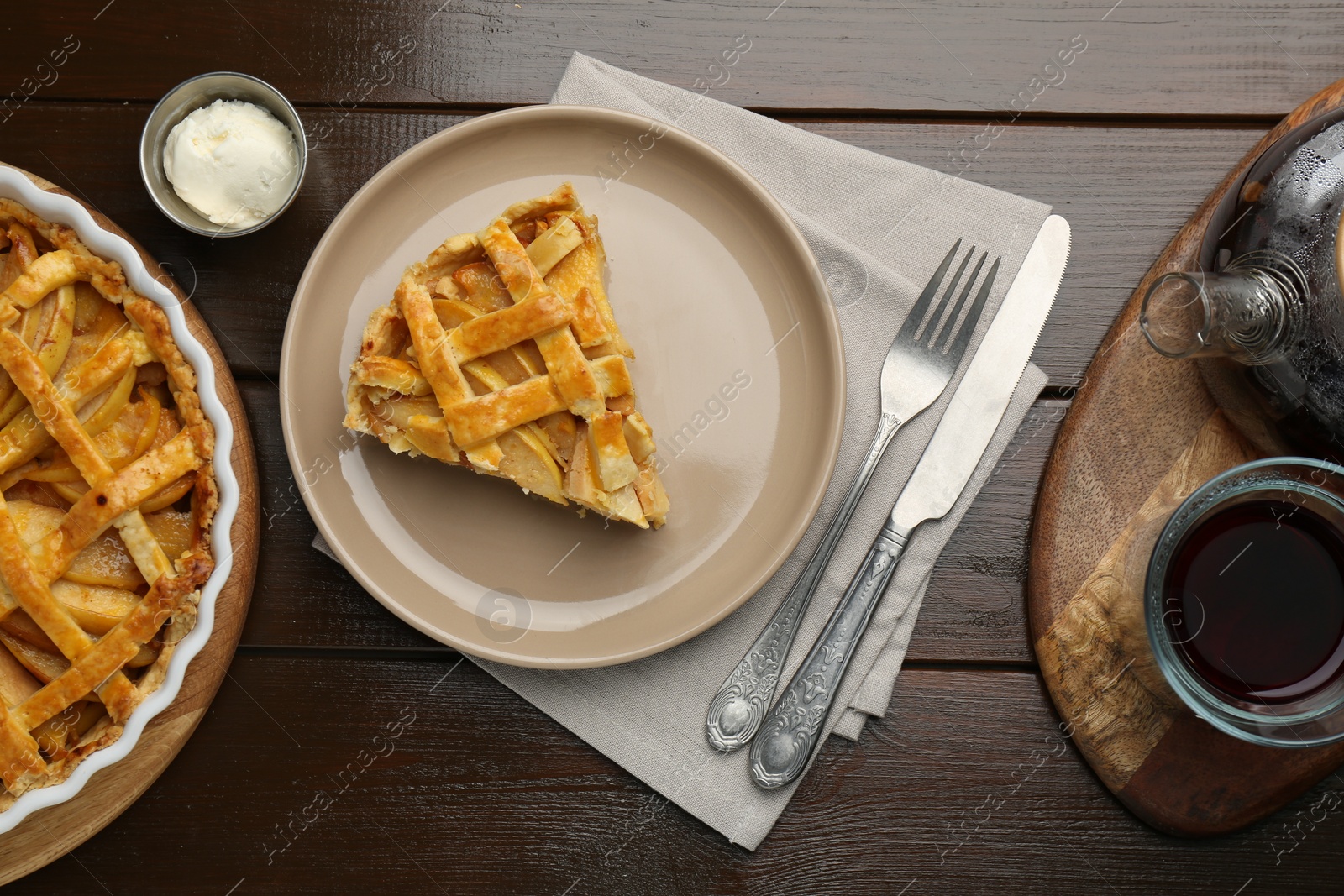 Photo of Tasty homemade quince pie served on wooden table, flat lay