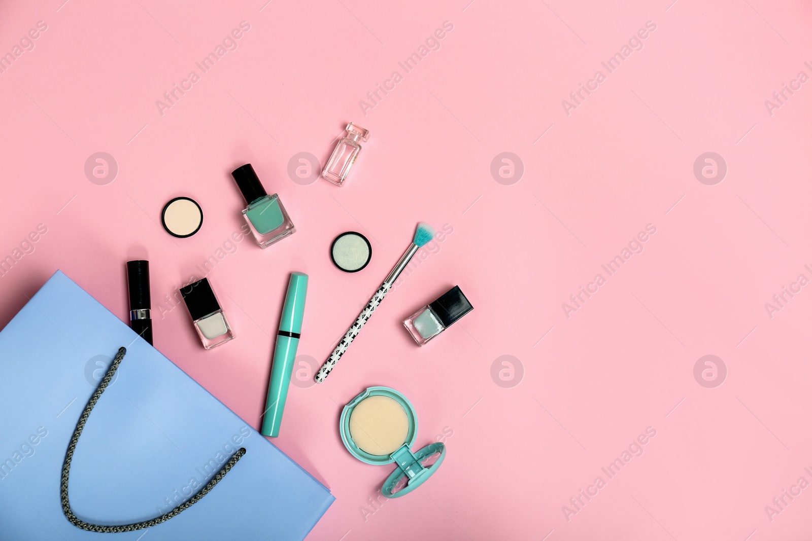 Photo of Flat lay composition with shopping bag and cosmetics on color background