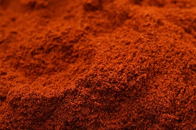 Photo of Aromatic paprika powder as background, closeup view