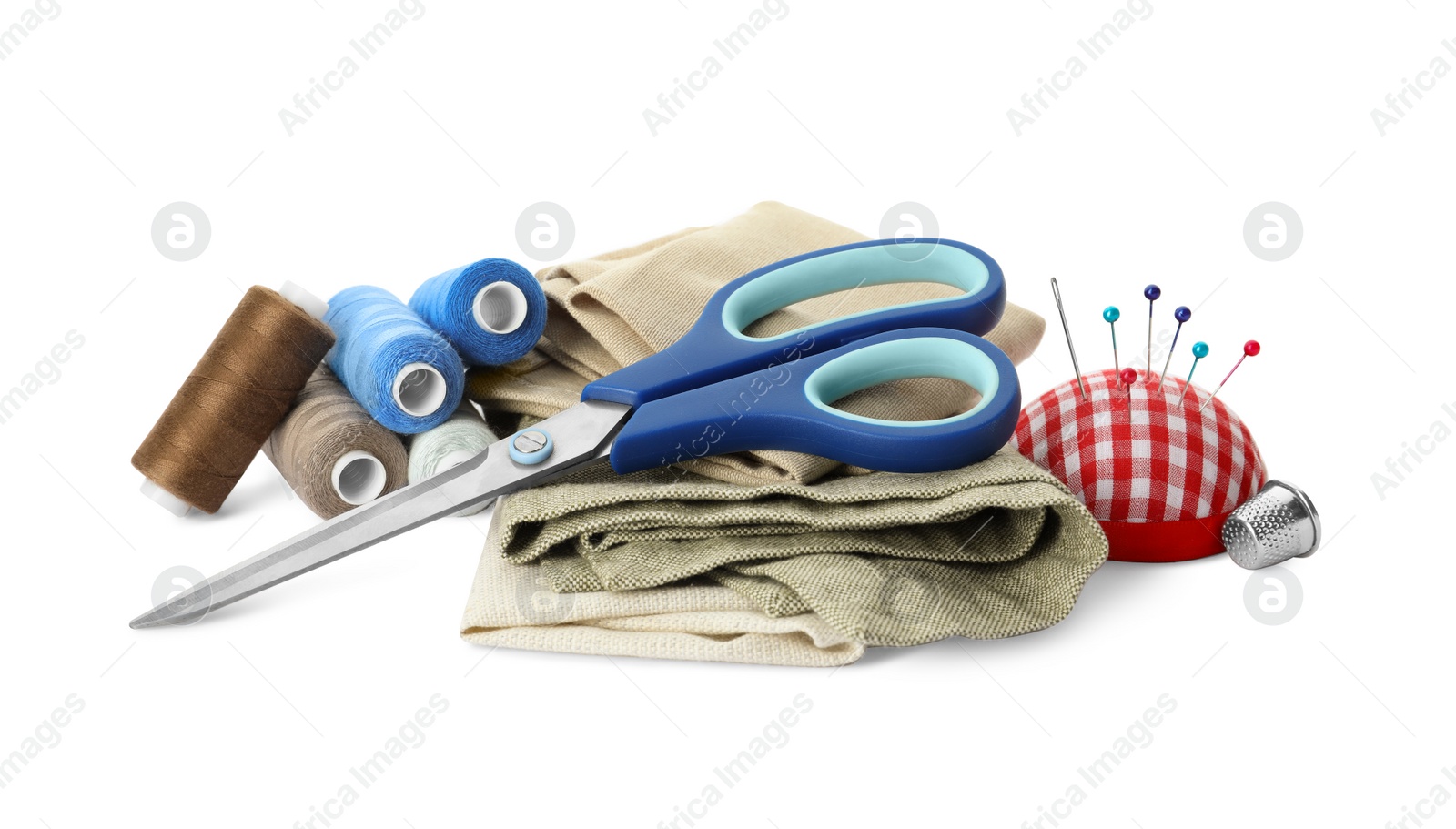 Photo of Scissors, spools of threads and sewing tools on white background