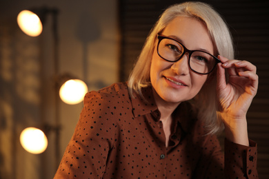 Photo of Beautiful mature woman in glasses at home