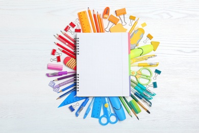 Flat lay composition with different school stationery on wooden background