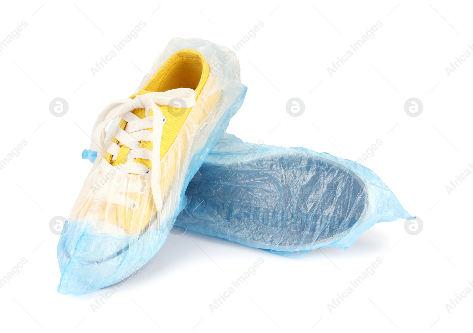 Photo of Sneakers in blue shoe covers isolated on white