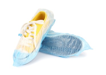 Photo of Sneakers in blue shoe covers isolated on white