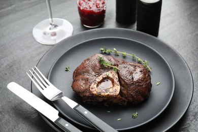 Tasty grilled beef meat served on black table, closeup