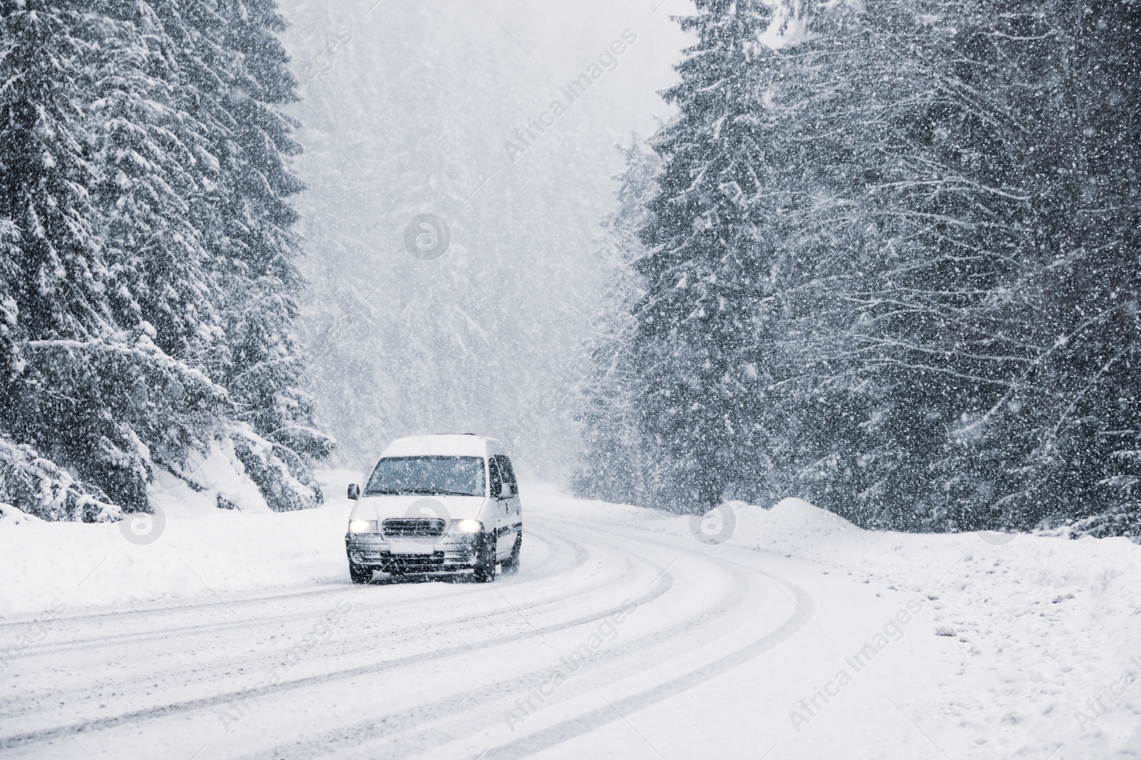 Photo of Snowy country road with modern car on winter day