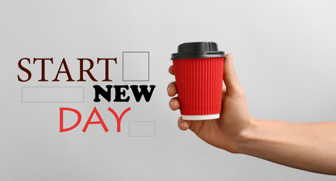 Man holding paper coffee cup and phrase START NEW DAY on light background, closeup. Banner design