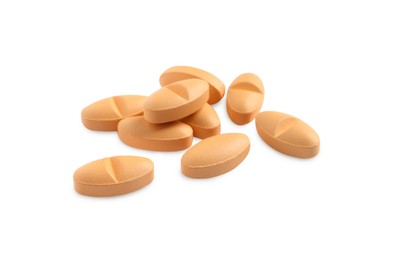 Photo of Many orange pills isolated on white. Medicinal treatment