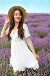 Young woman in lavender field on summer day