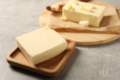 Block of tasty butter on grey table