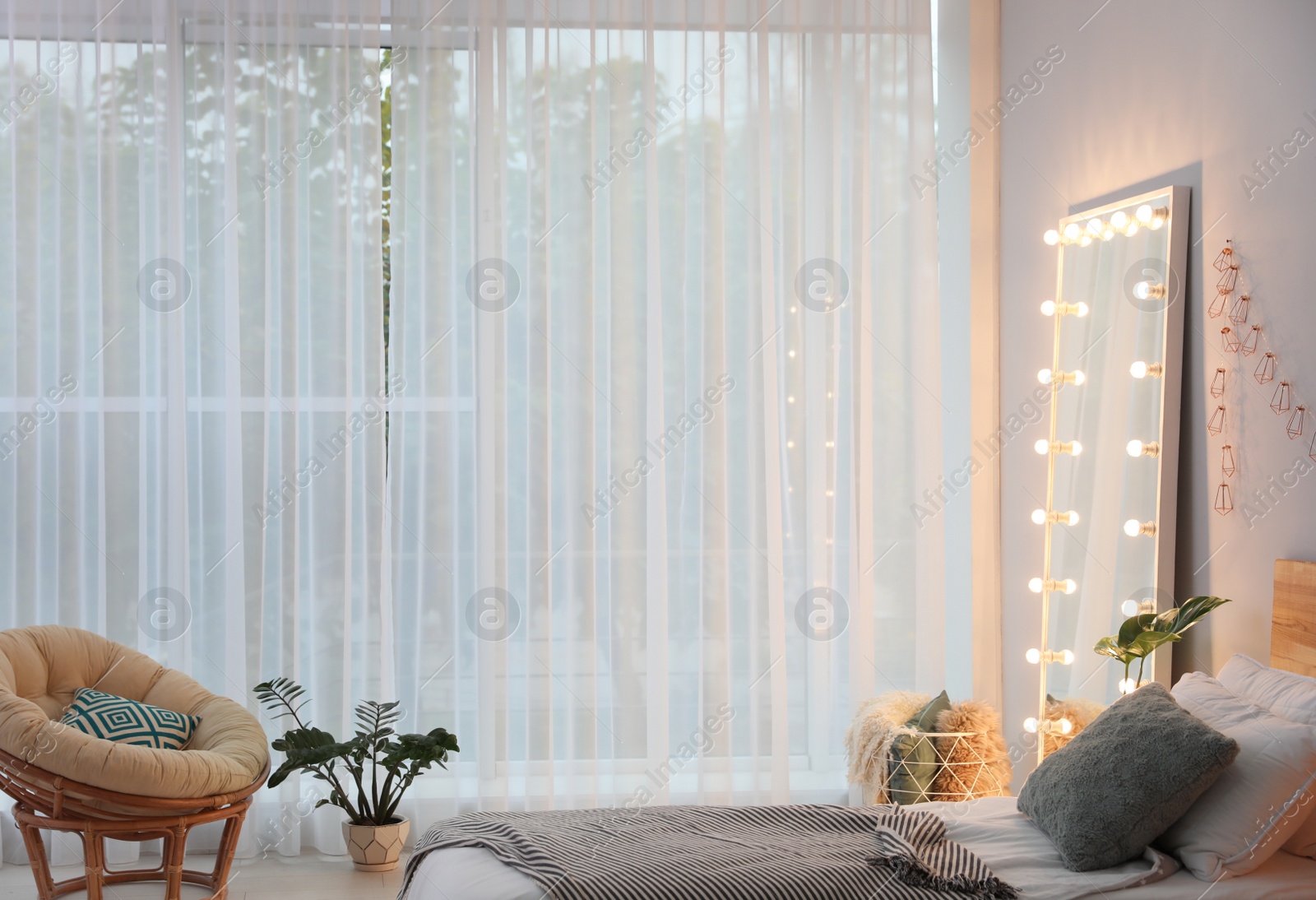 Photo of Large mirror with light bulbs in stylish room interior